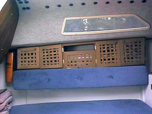 Port side storage cubby holes showing hinged seat bolster, Precision 21